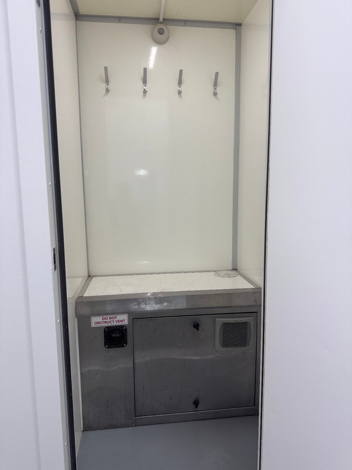 Drying room inside the BOXD 12ft welfare unit with coat hooks and generator access